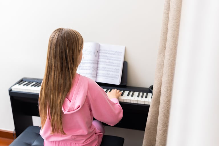 Young girl practicing piano